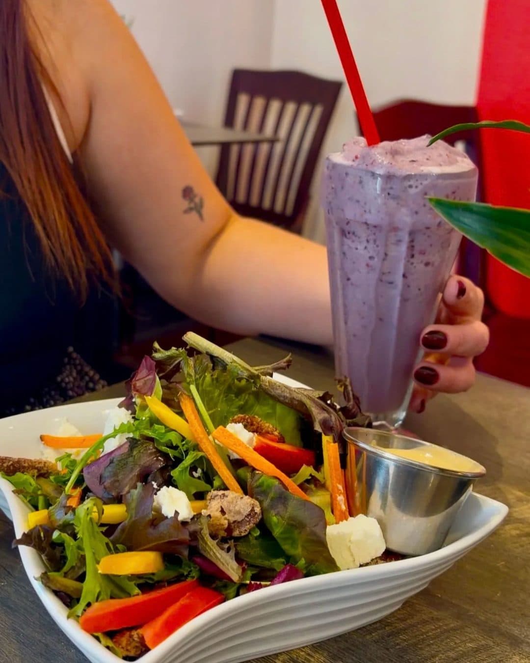 A mixed green salad with a berry smoothie